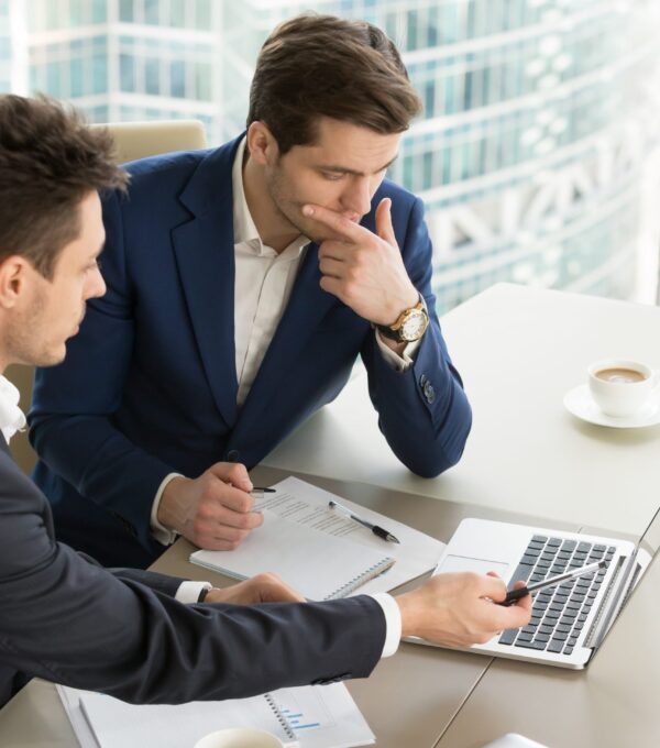 Two men in a meeting discussing audit services